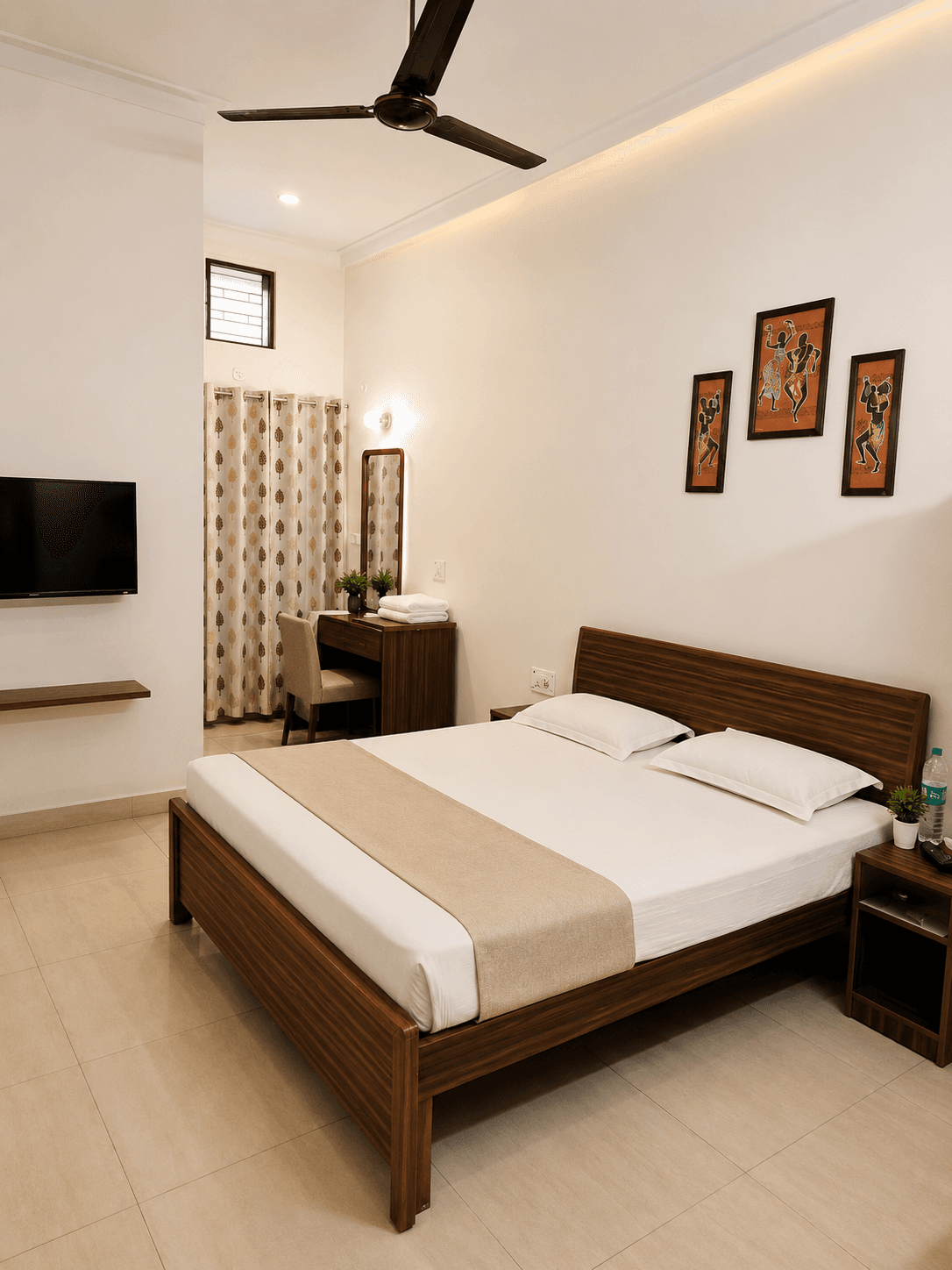 Deluxe Room at Hotel Vasant with warm interiors and comfortable bedding